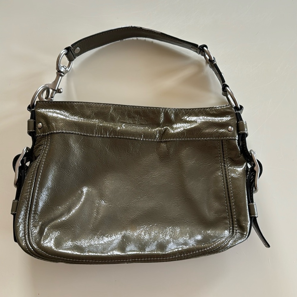 Patent leather Coach purse with silver metal hardware.